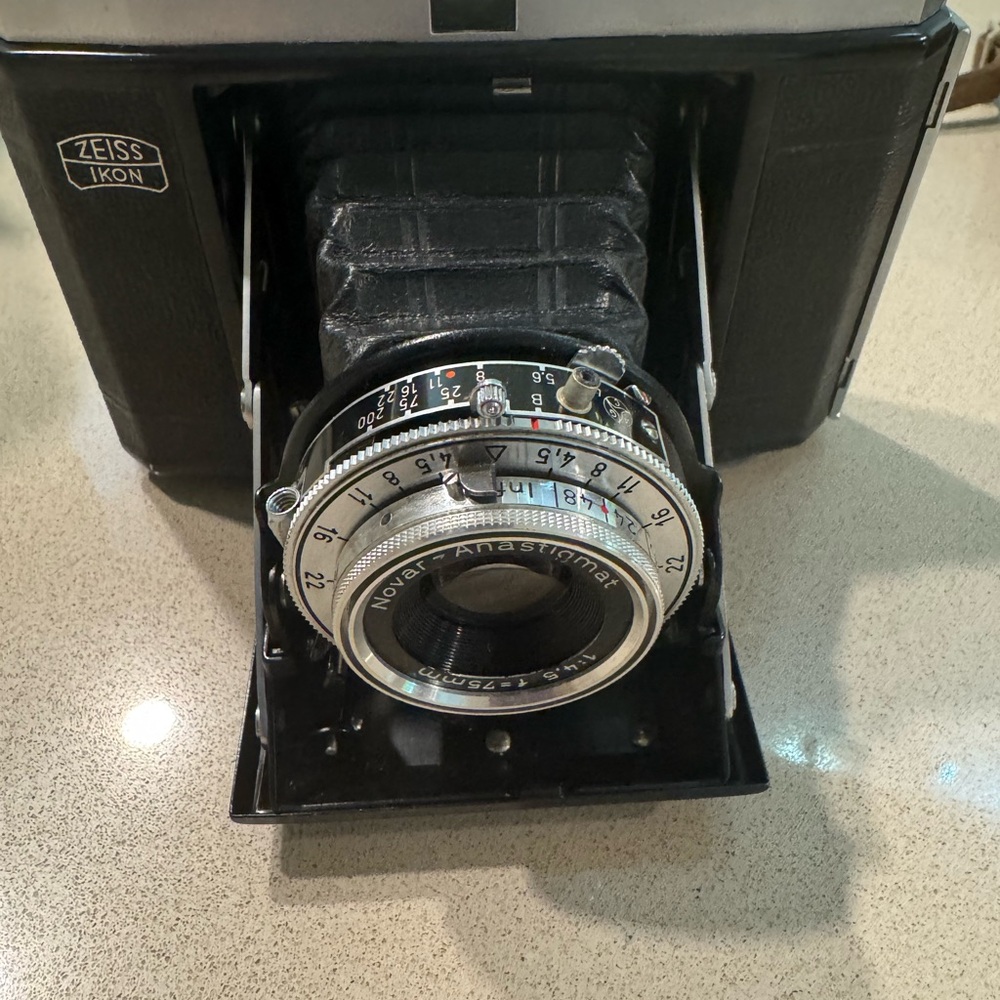 Black Vintage Camera not tested  comes with case and stand